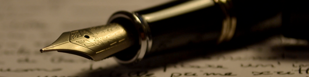 a closeup of a classic fountain pen with a piece of paper in the background